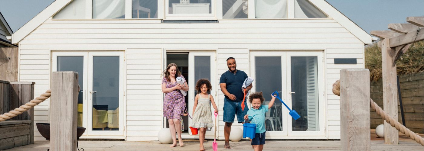 Family leaving a house to go to the beach.